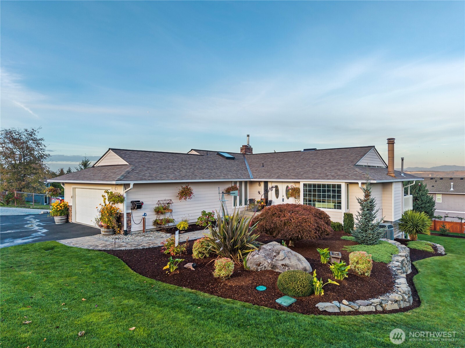 Single-story home with an attached garage and landscaped front yard.
