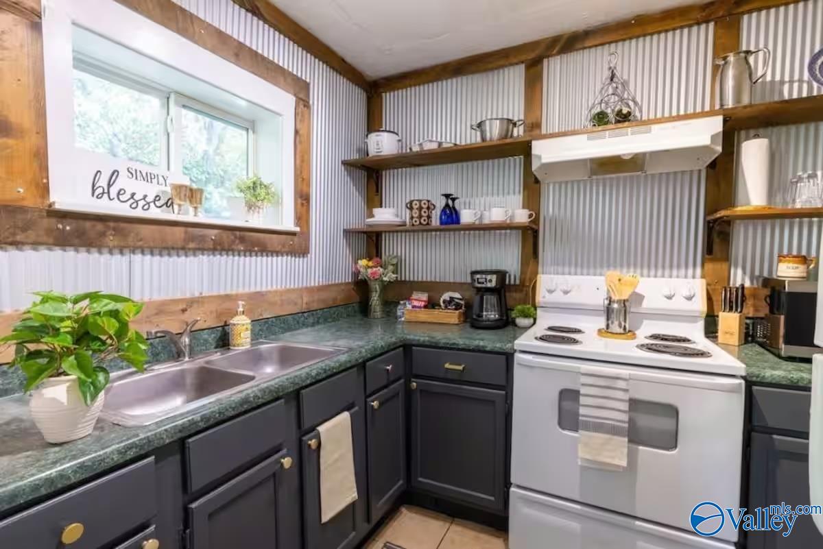 Kitchen with corrugated metal walls, dark cabinets, green countertops, and a white electric range.