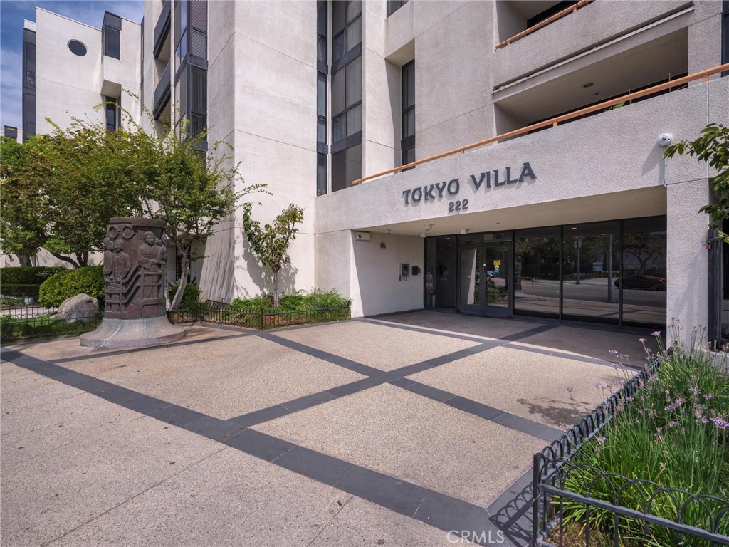 Tokyo Villa entrance with a stone monument and landscaped courtyard.