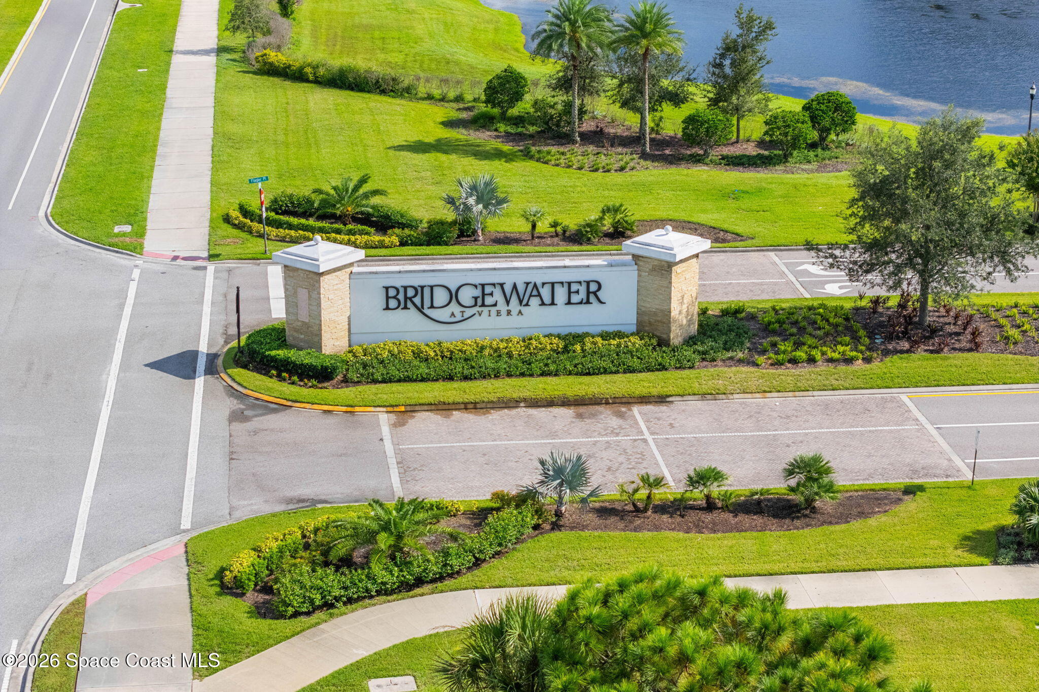 Aerial view of the Bridgewater at Viera entrance sign beside landscaped grounds and a pond.