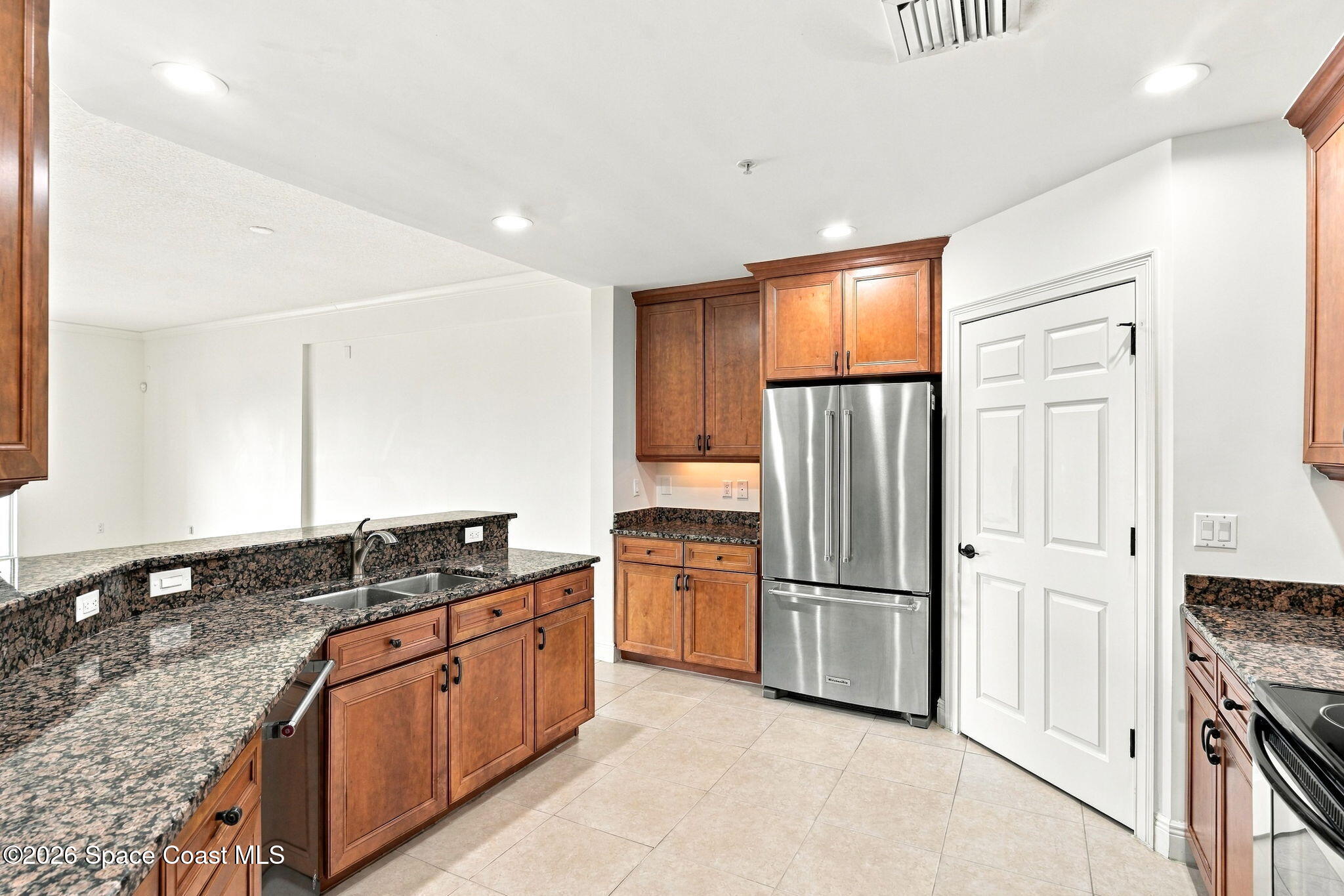 Kitchen with wood cabinets, granite counters, and stainless steel appliances.
