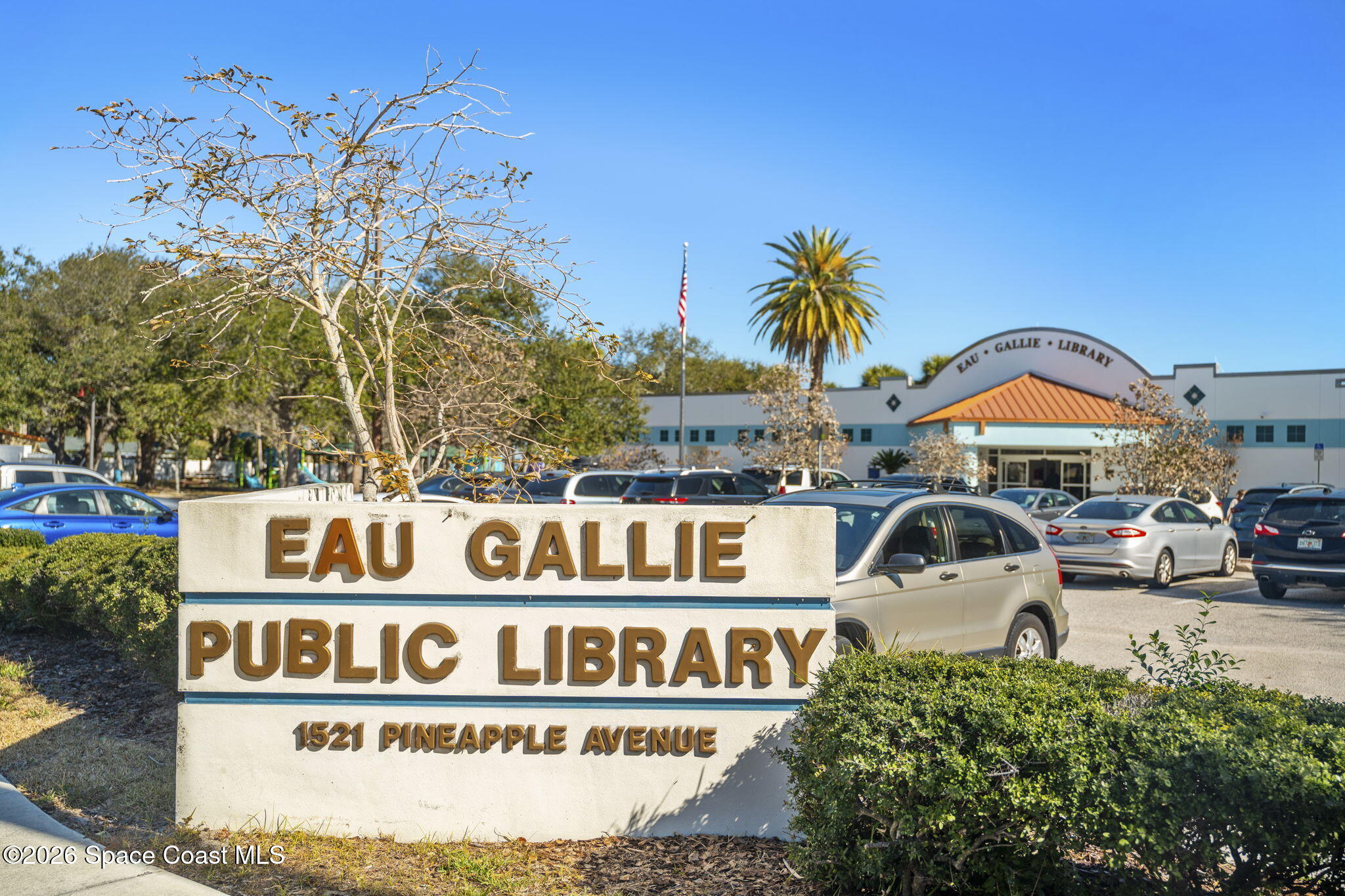 Eau Gallie Public Library, with its roadside sign displaying the address 1521 Pineapple Avenue.