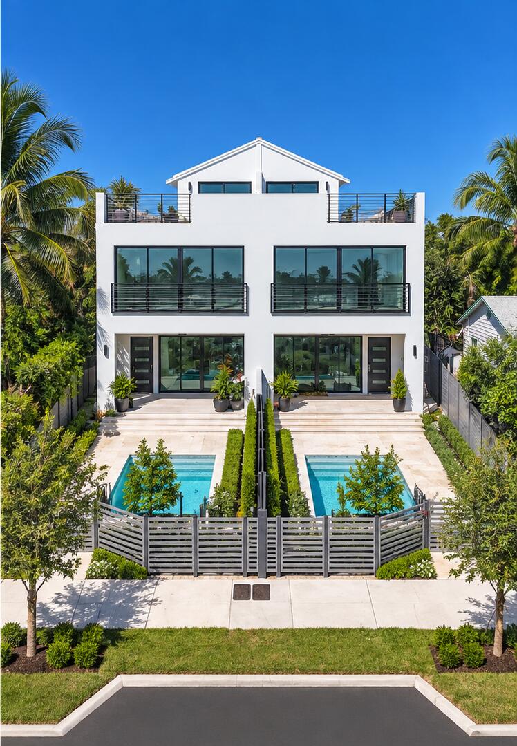 Twin modern white homes with balconies and separate pools, framed by palm trees.