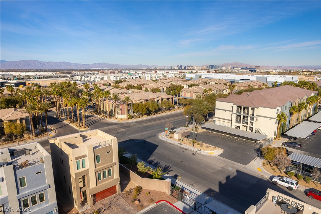 Aerial view of Las Vegas homes and apartments, with the city skyline and mountains in the distance.