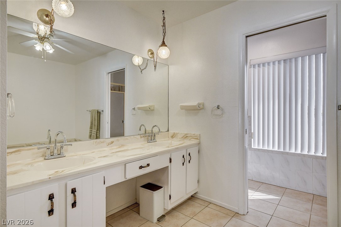 Bathroom with a long double-sink vanity, marble-look countertop, and large mirror.