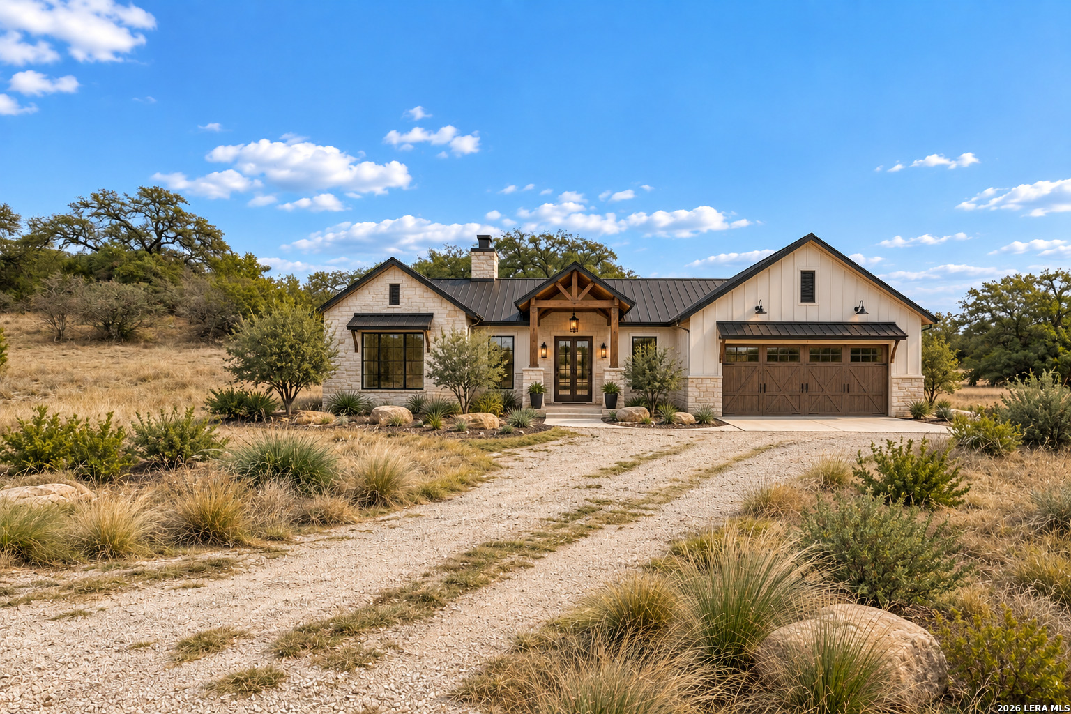 Ranch-style home with a timber-covered entry, stone siding, and a wooden garage door amid dry landscaping.