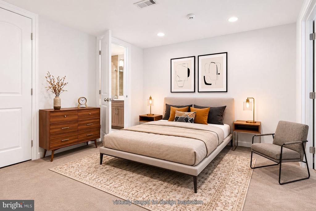 Virtually staged bedroom with a neutral bed, patterned rug, wood dresser, and framed abstract art.