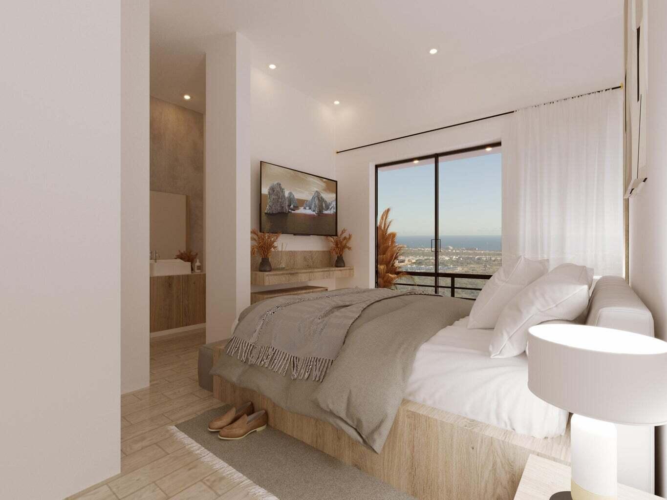 Penthouse bedroom with a neutral bed and sliding glass doors overlooking the city and sea.