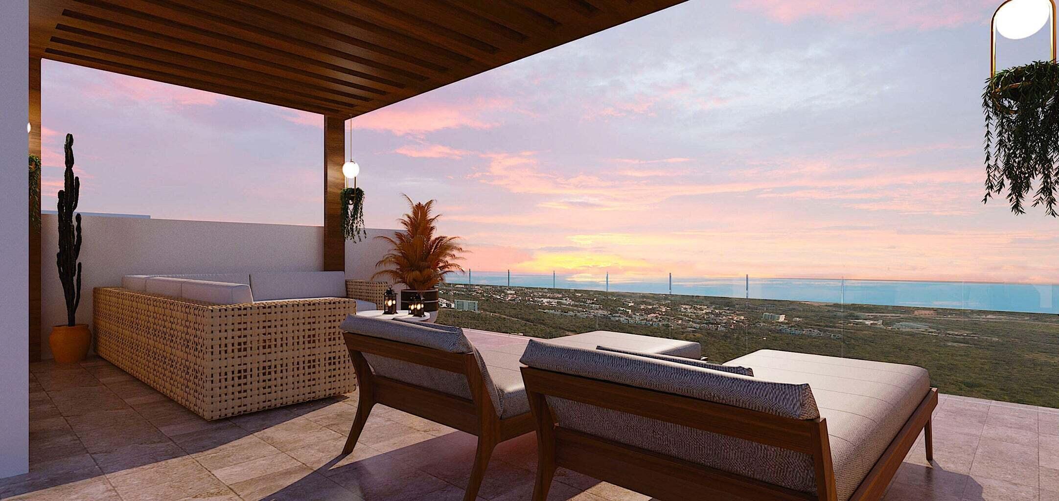 Penthouse terrace with cushioned lounge seating and ocean views at sunset.