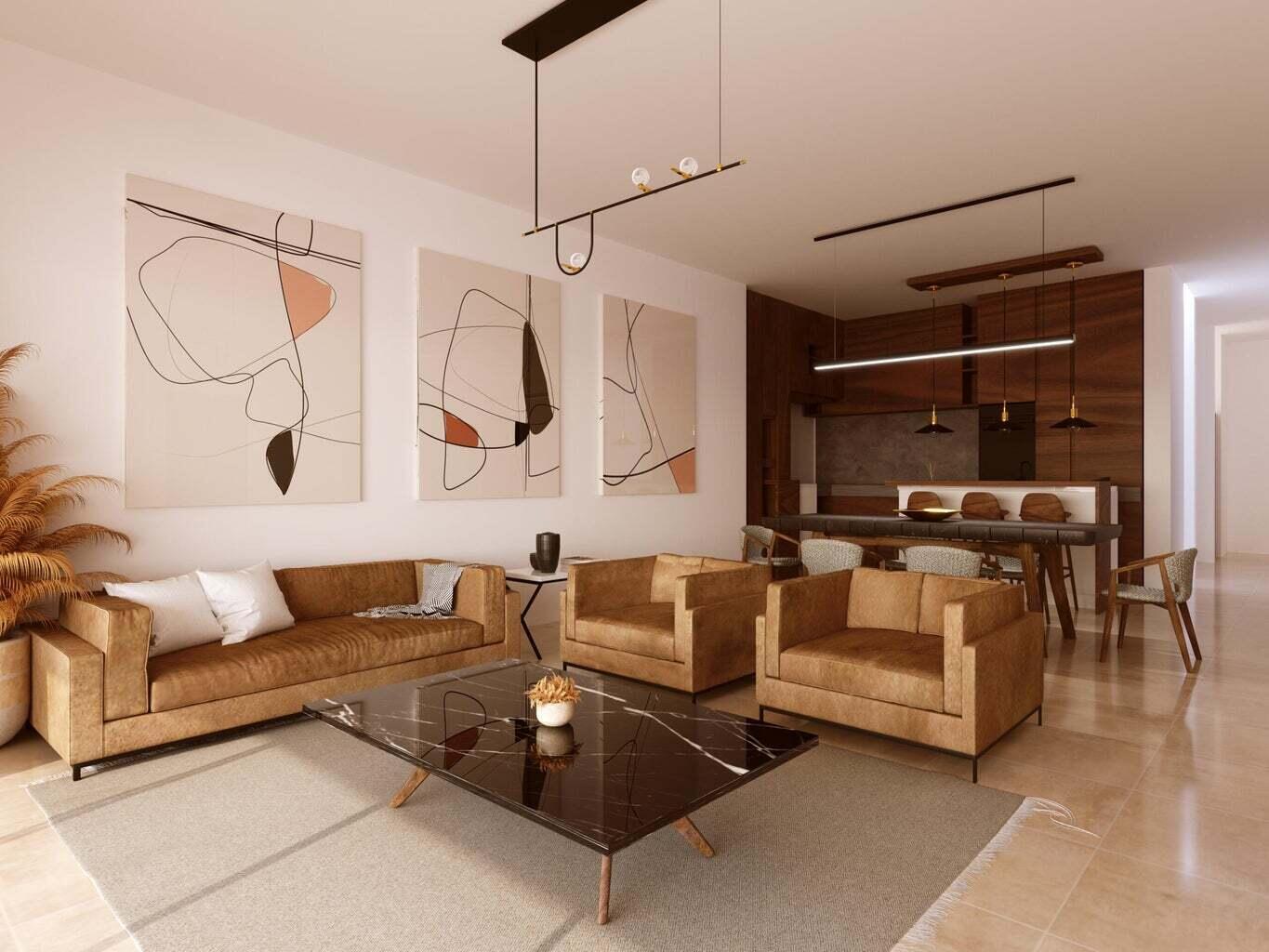 Furnished penthouse living room with tan leather sofas, abstract art, and an open dark wood kitchen.