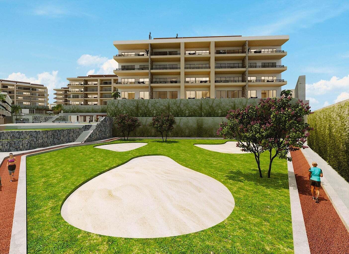 Condominium buildings with broad balconies overlook a landscaped lawn and curved stone paths.
