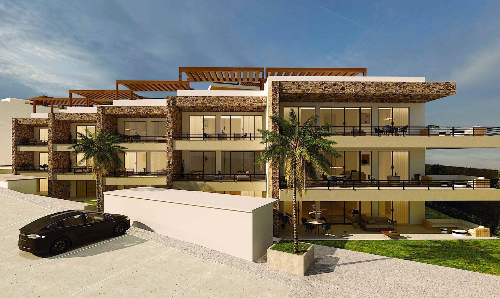 Tramonti Paradiso penthouse building with stone accents, broad balconies, rooftop pergolas, and palm trees.