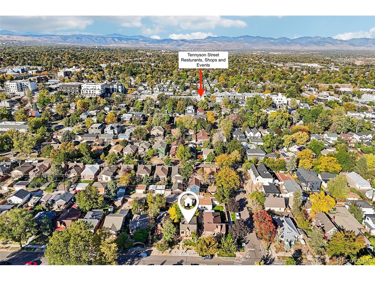 Aerial neighborhood view with a house marker, Tennyson Street highlighted, and mountains on the horizon.