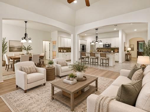 Open-plan living room with neutral furnishings, adjoining dining area, and kitchen island.