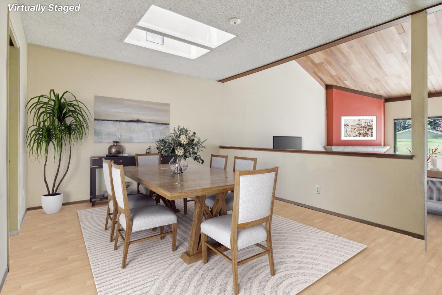 Virtually staged dining room with a wooden table beneath a high ceiling with wood paneling.