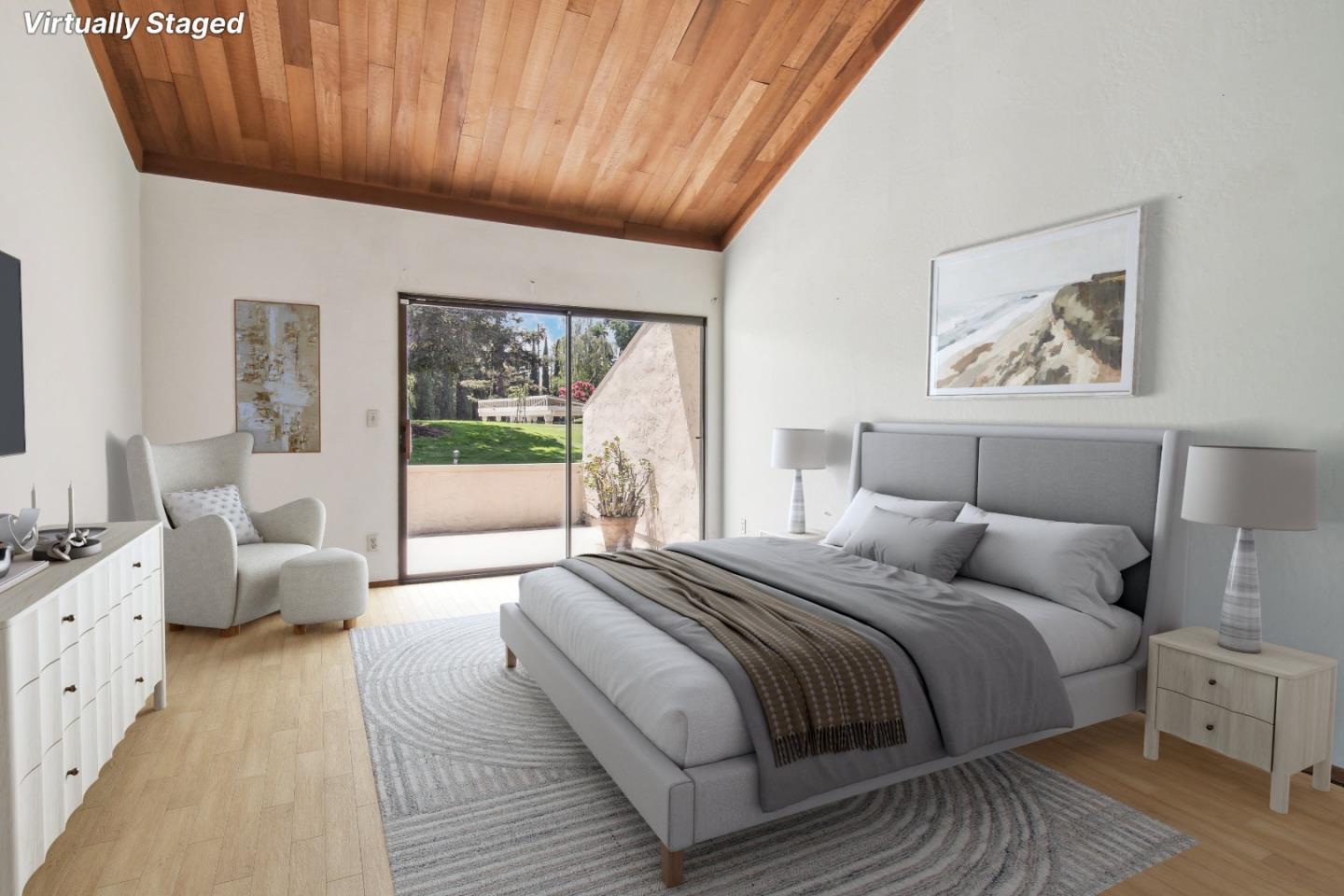 Virtually staged bedroom with a gray bed, vaulted wood ceiling, and sliding glass door to the patio.