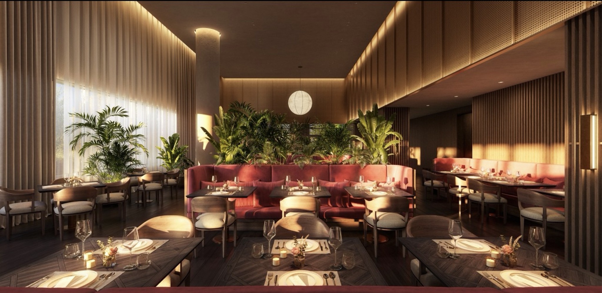 Dining lounge with pink booths, set tables, and indoor plants.