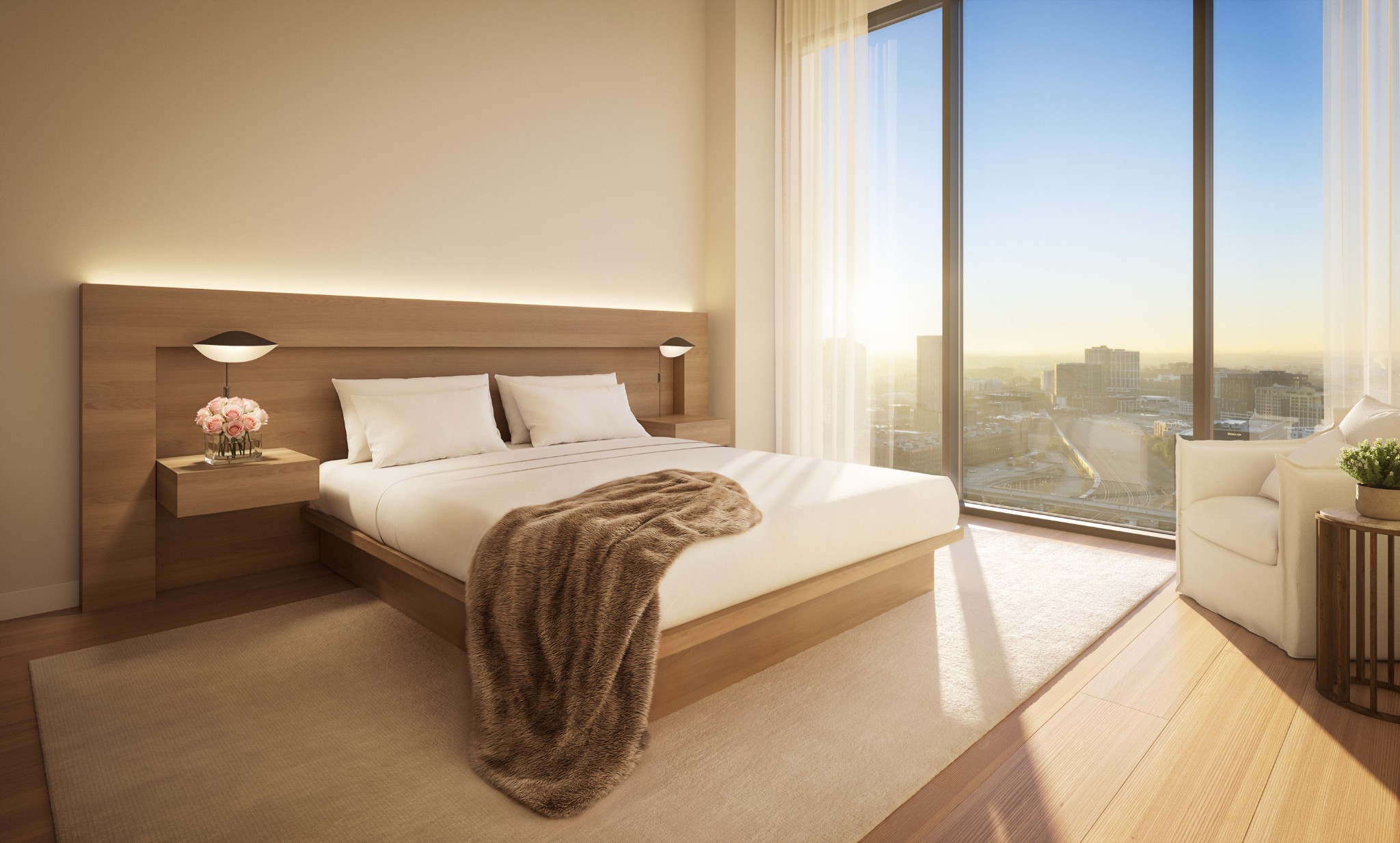 Bedroom with a wooden bed and floor-to-ceiling windows overlooking the city skyline.