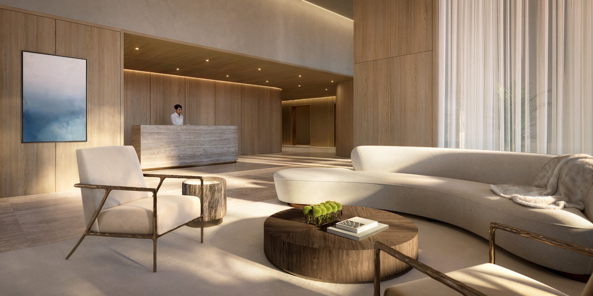 Modern lobby with a stone reception desk, wood walls, and curved cream seating.