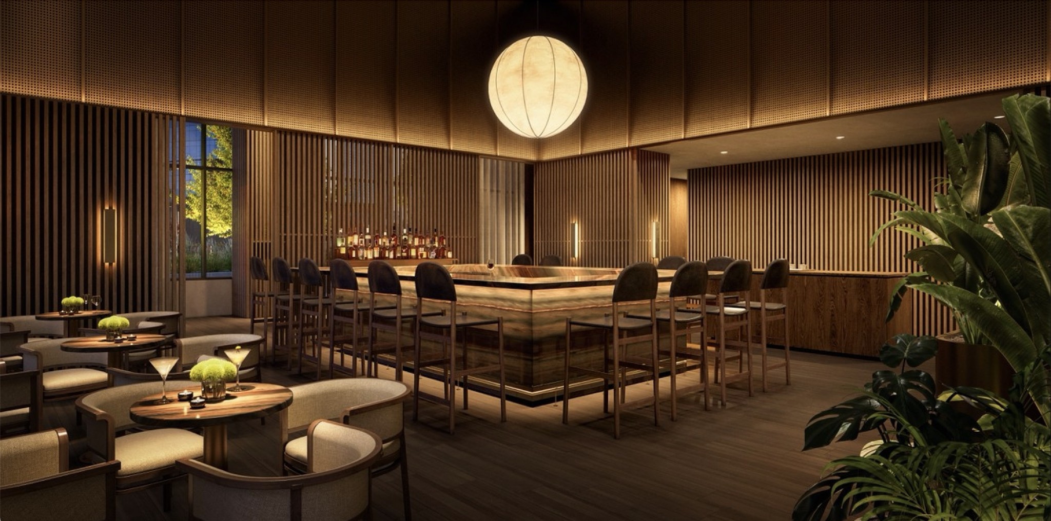 Interior lounge with a central bar, high stools, and warm wood finishes.