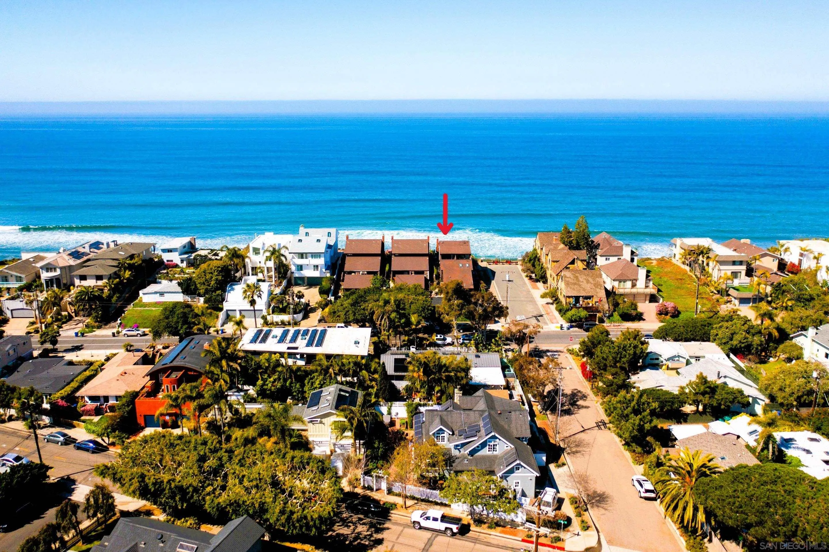 Aerial view of 194 Neptune Ave-Encinitas CA-92024-Leucadia-beachside home marked near the shoreline, surrounded by coastal residences, palm trees, and ocean horizon