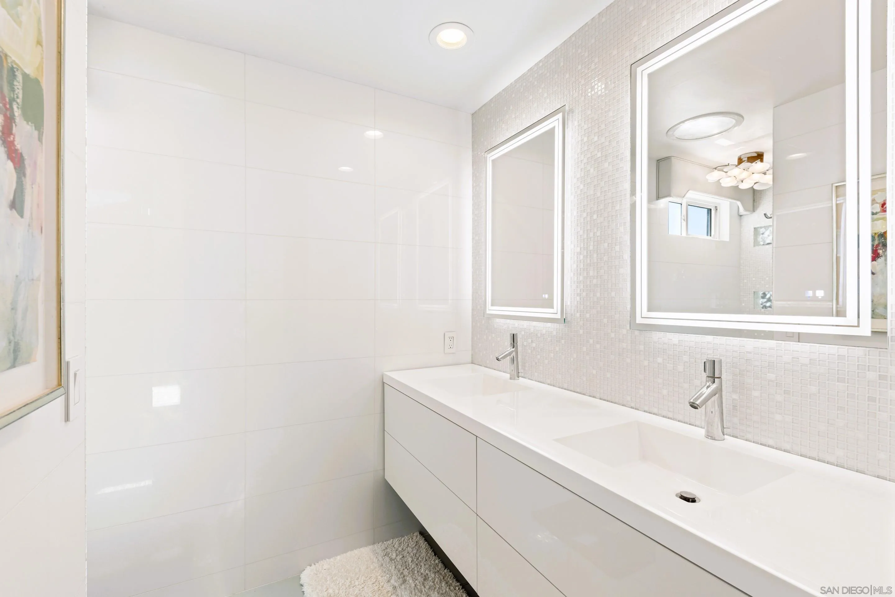 Primary bathroom at 194 Neptune Ave-Encinitas-CA-92024 Leucadia-featuring glass-enclosed shower, mosaic tile walls, modern fixtures, and natural light in this oceanfront home listed by FW Property Group