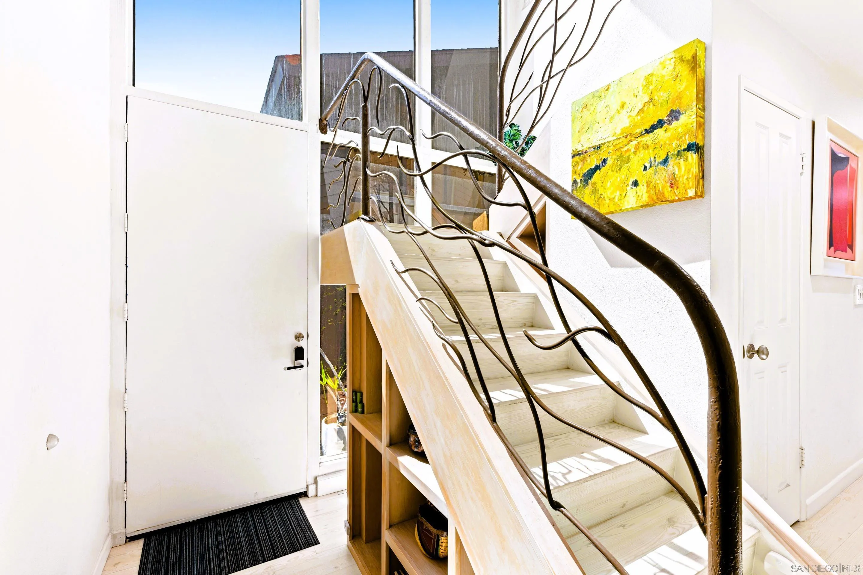 Contemporary entryway at 194 Neptune Ave-Encinitas-CA-92024-Leucadia-neighborhood-featuring sculptural staircase, natural light, and artistic coastal design in this oceanfront home listed by FW Property Group