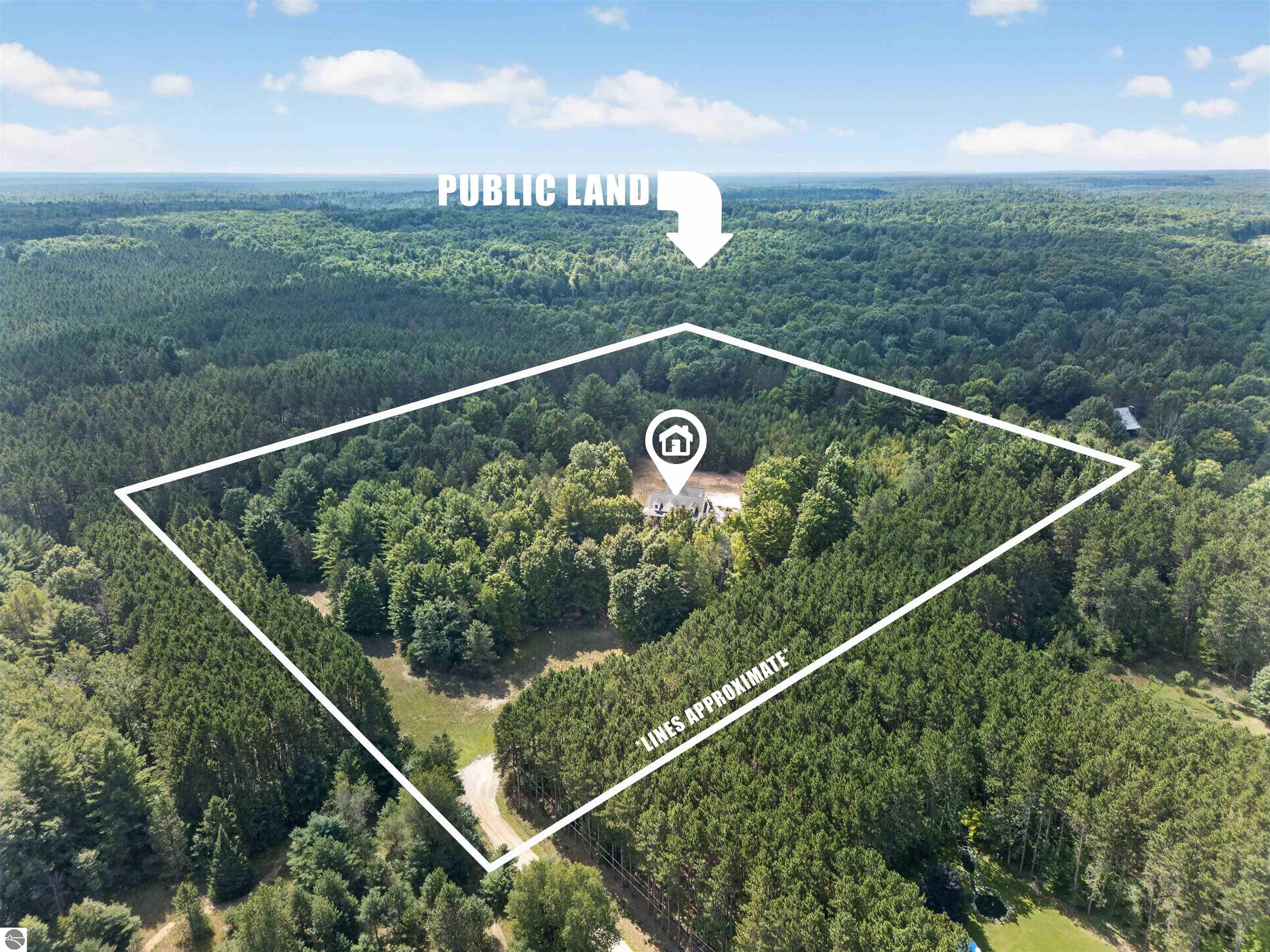 Aerial view of a forested property outlined around a house, with public land beyond.