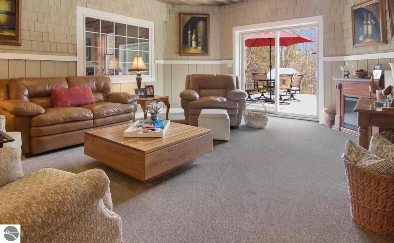 Living room with leather seating, a wooden coffee table, and sliding doors to a patio.