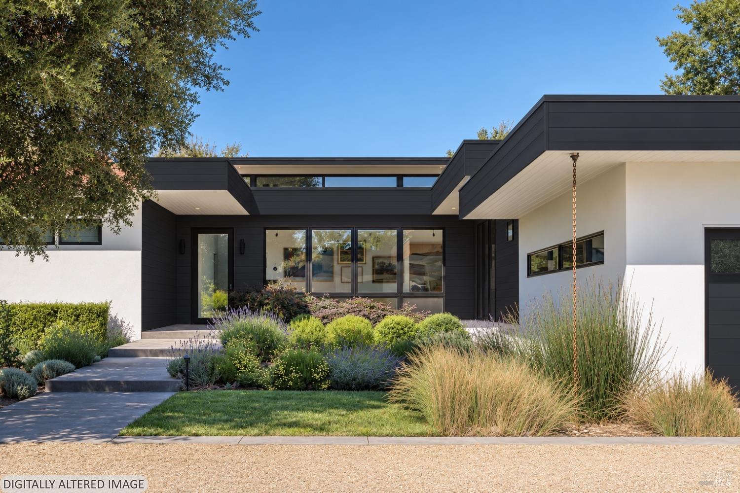 Contemporary home with a dark-framed entry, broad windows, and a landscaped front path.