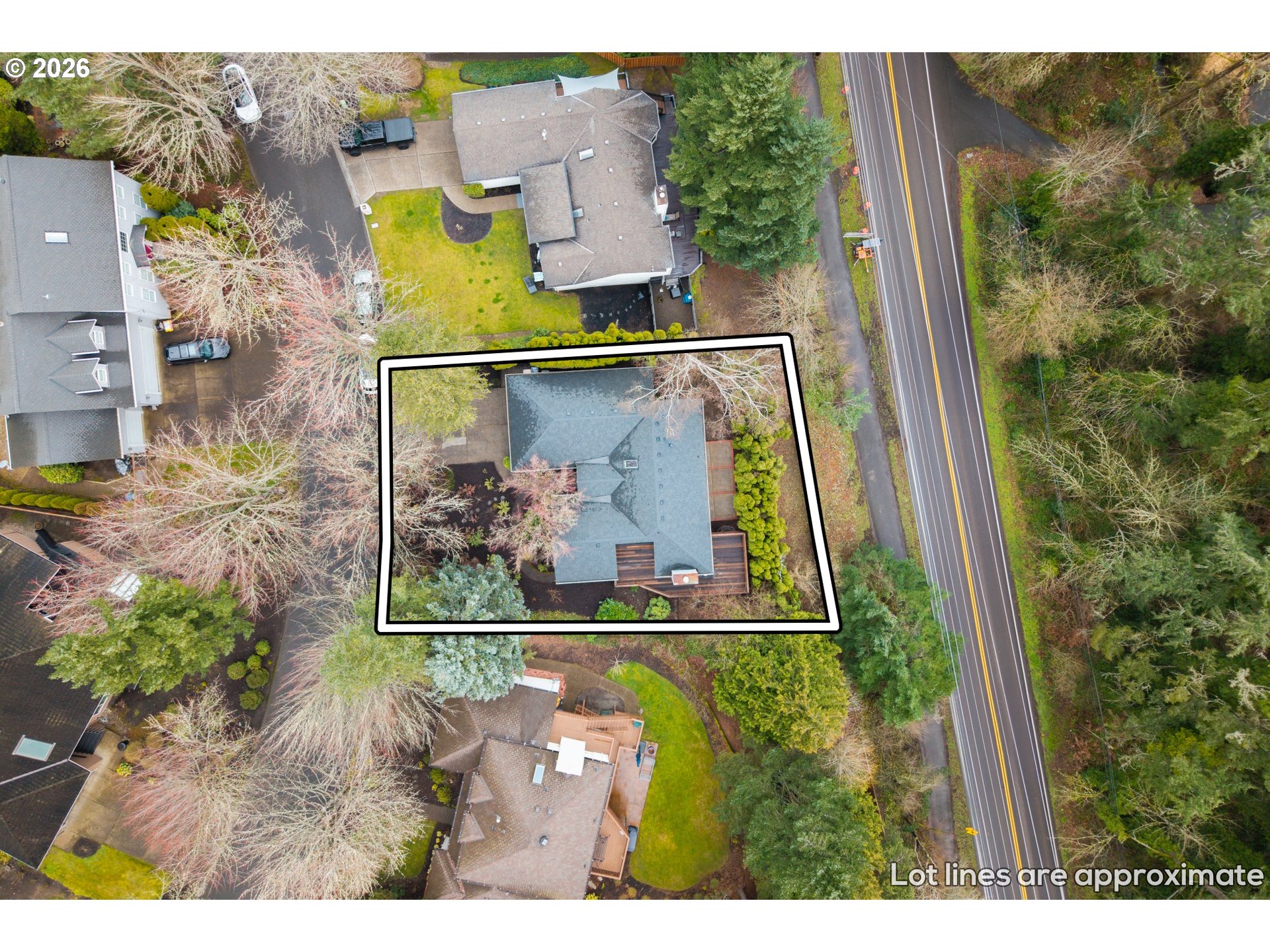Aerial view of the home and approximate lot boundaries beside a road.
