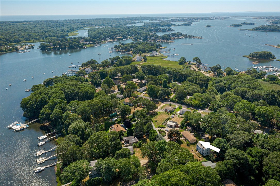 Aerial view of 70 Quagnut Drive, with an arrow marking the home near the harbor.
