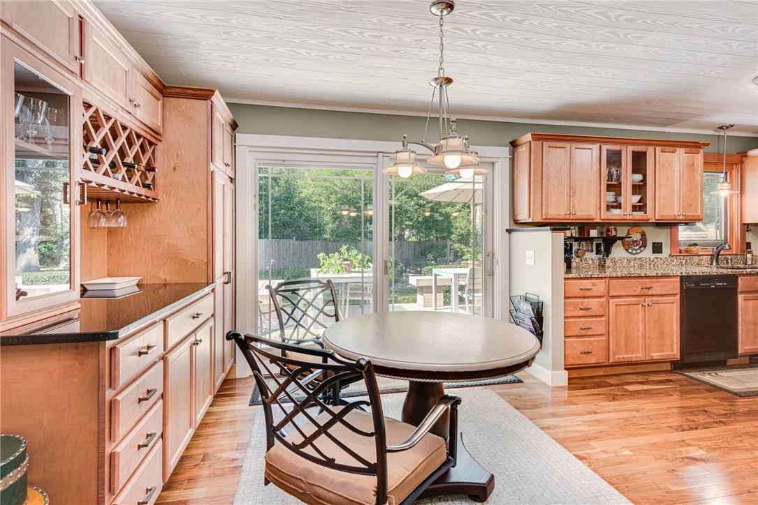 Kitchen and dining area with wood cabinets, a round table, and sliding doors to the patio.