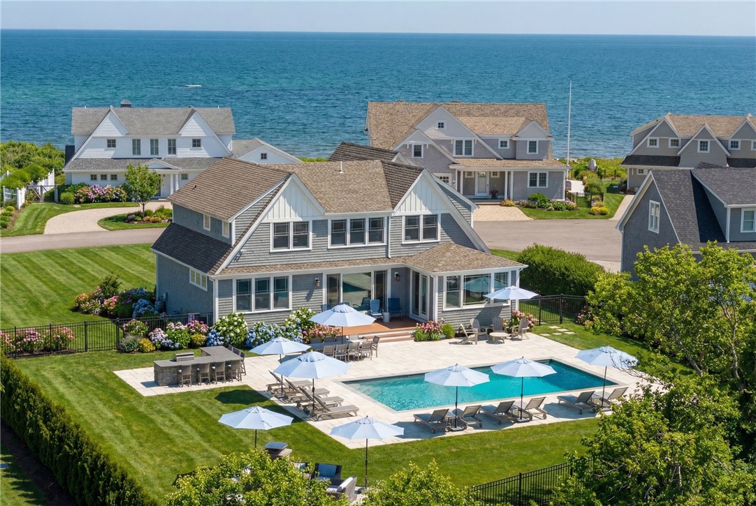 Coastal home with a pool and patio overlooking the ocean.