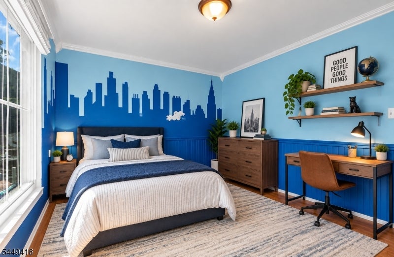 Bedroom with blue city-skyline mural, white-and-blue bedding, and a desk by the window.