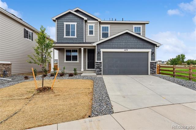 Two-story gray home with a dark shingle accent, attached garage, and wide concrete driveway.