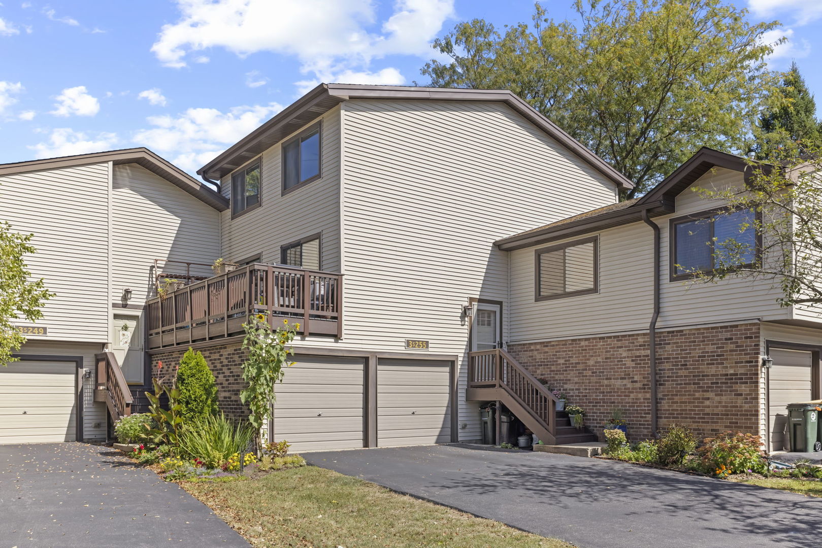 Townhouse exterior at 3S255, with attached garages and a raised wooden deck.