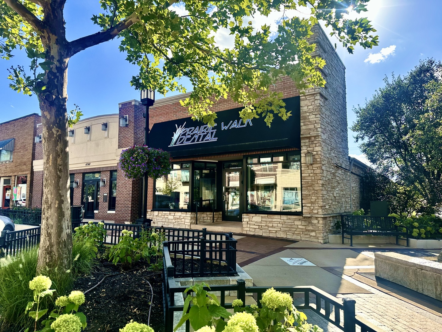 Commercial storefront at 4746 Main Street with a stone facade and Trail Walk Dental sign.