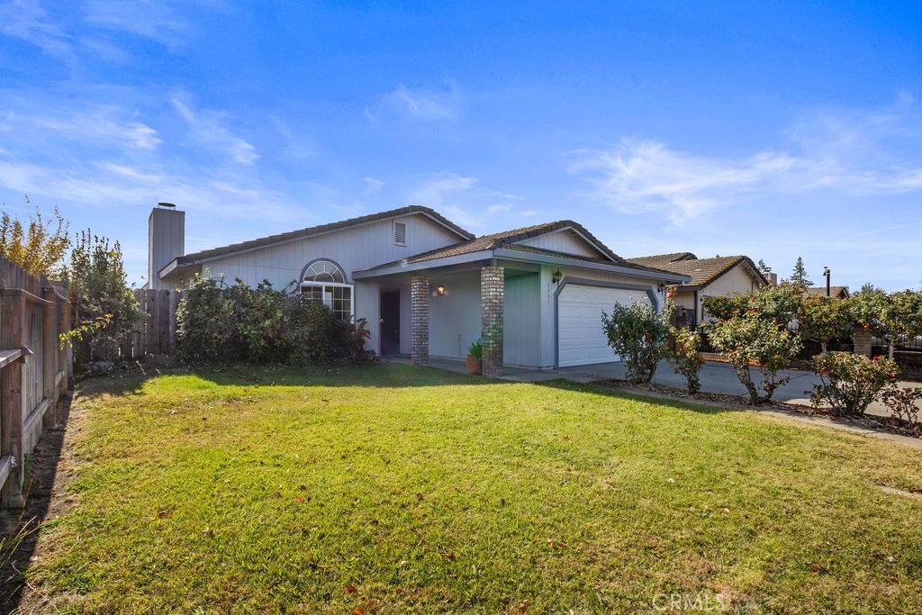 Single-story home with a two-car garage and broad grassy front yard.
