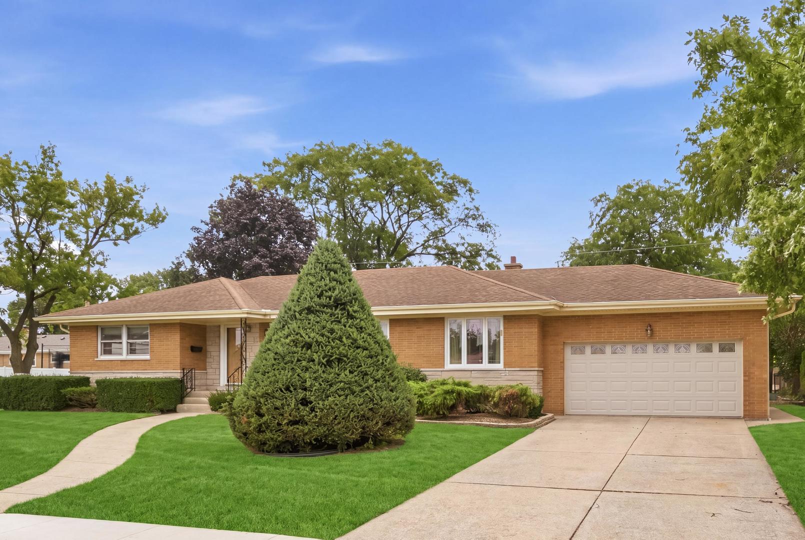 Single-story red-brick home with a two-car garage, curved walkway, and landscaped front lawn.