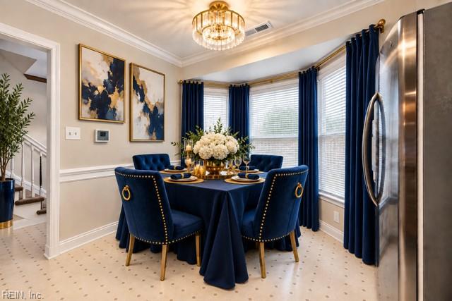 Dining room with a navy-draped table, gold-trimmed chairs, blue curtains, and a chandelier.
