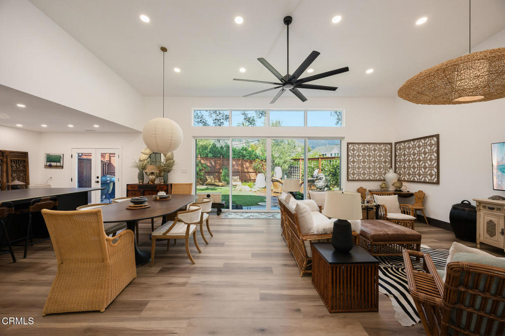 Open-plan living and dining room with high ceilings and sliding doors to the backyard.