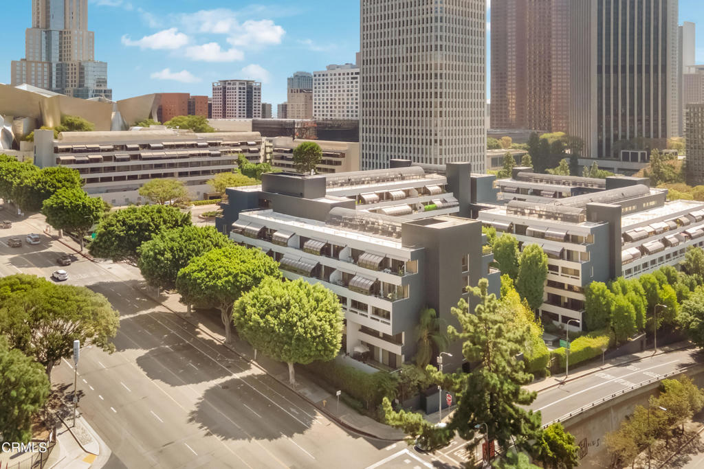 Residential complex among downtown Los Angeles high-rises, viewed from above.