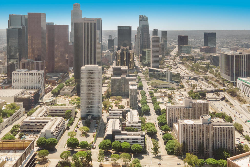 Aerial view of downtown Los Angeles with high-rises and freeway ramps.