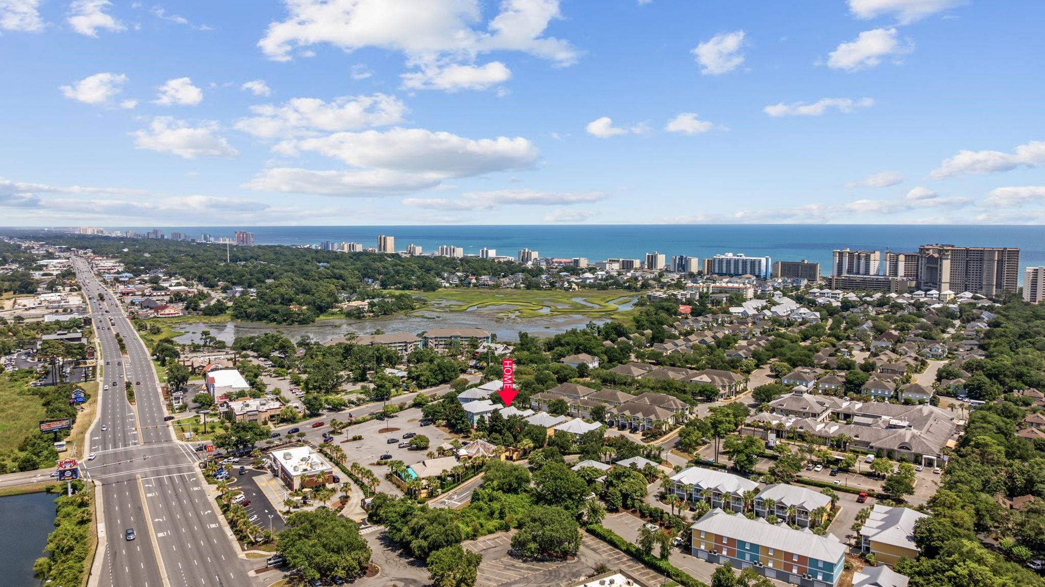 Aerial view of the property near a marsh, major road, and North Myrtle Beach oceanfront.