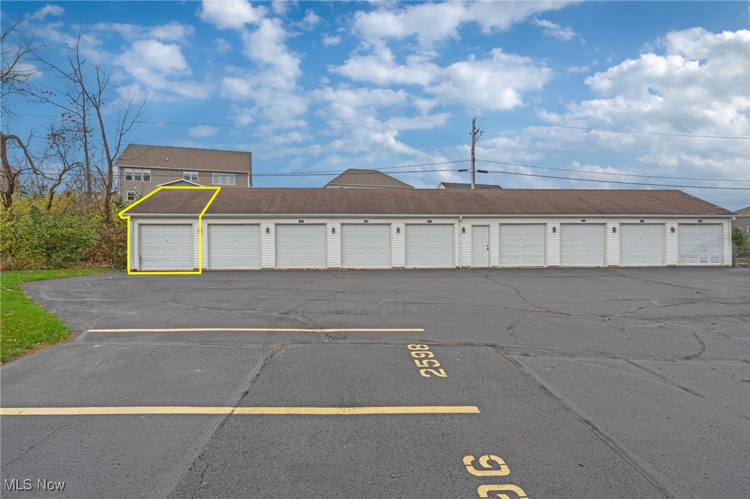 White garage row with one unit outlined in yellow beside pavement marked 2598.