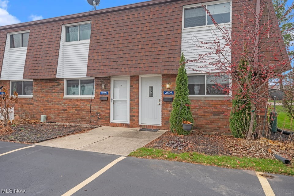 Brick townhouse with a white entry door, unit number 2598, and neighboring homes along the row.
