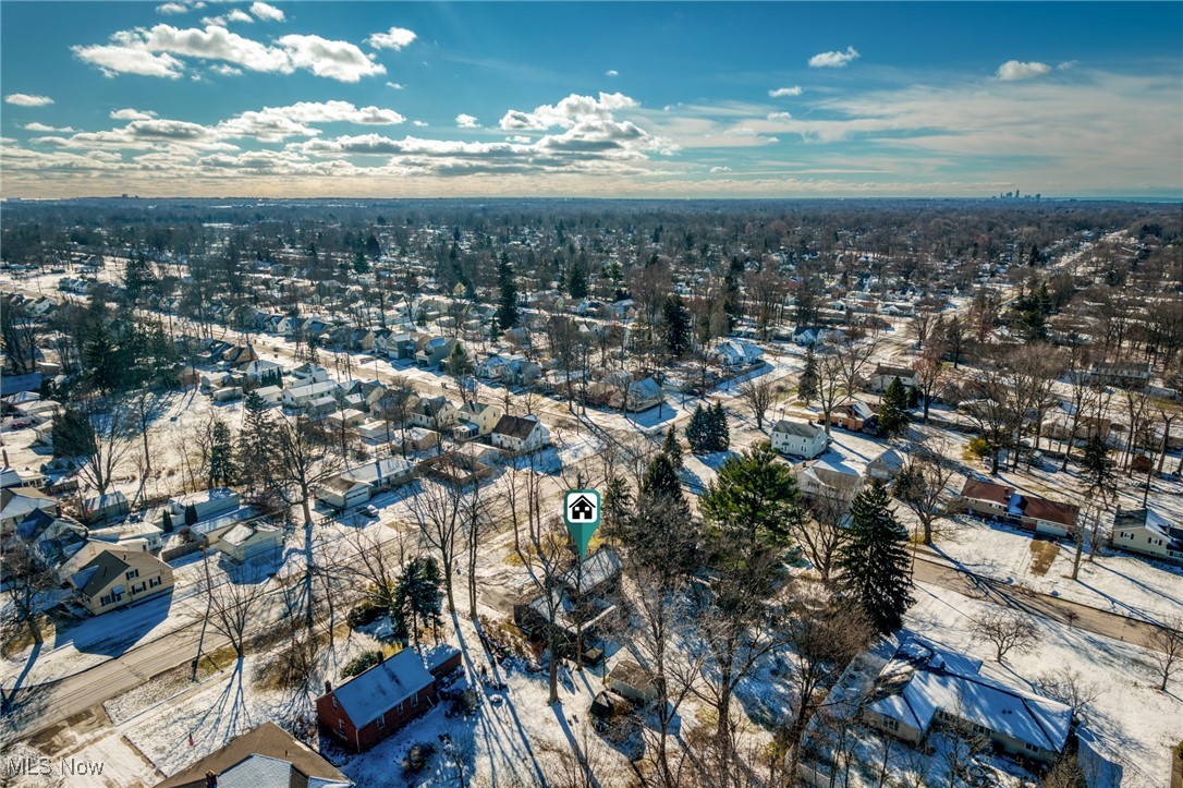 Aerial view of a snow-covered neighborhood, with the featured home marked near the center.