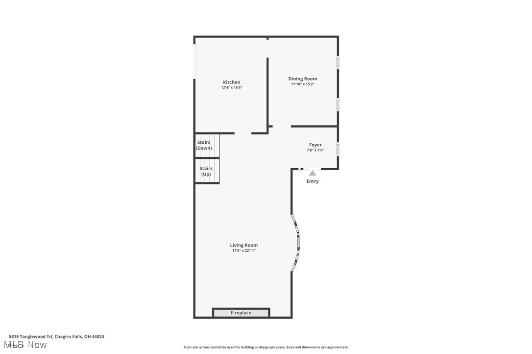 Floor plan showing a kitchen, dining room, foyer, living room with fireplace, and two stairways.