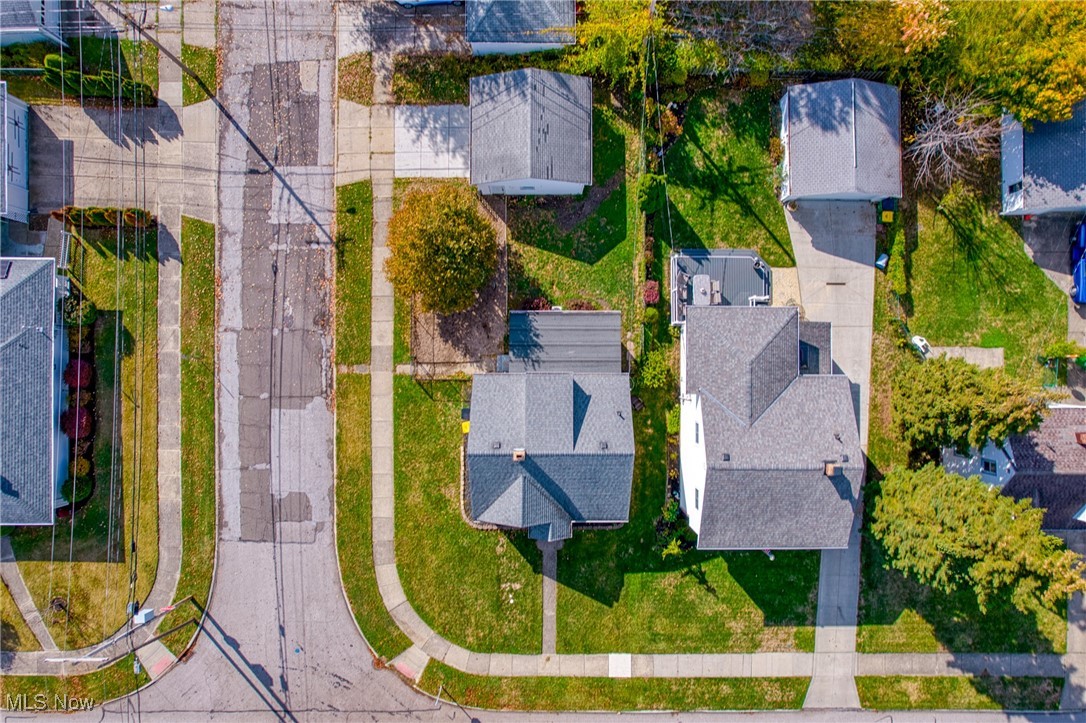 Aerial view of a Willowick residential street, with detached homes, lawns, and autumn trees.